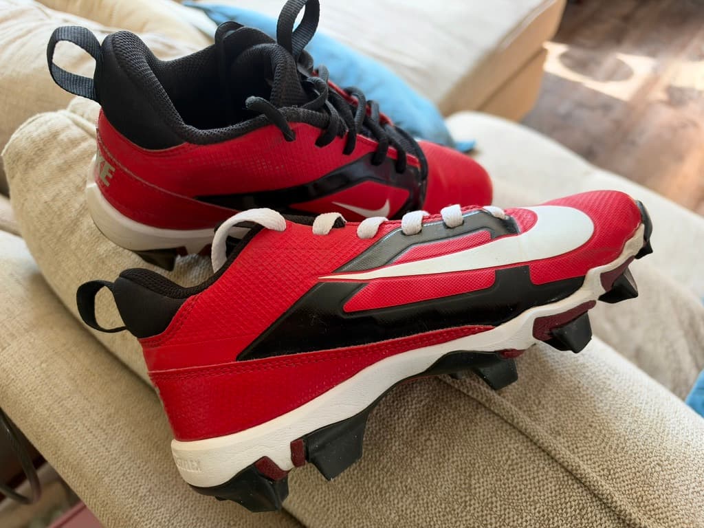 My son’s first red, black and white Nike cleats.